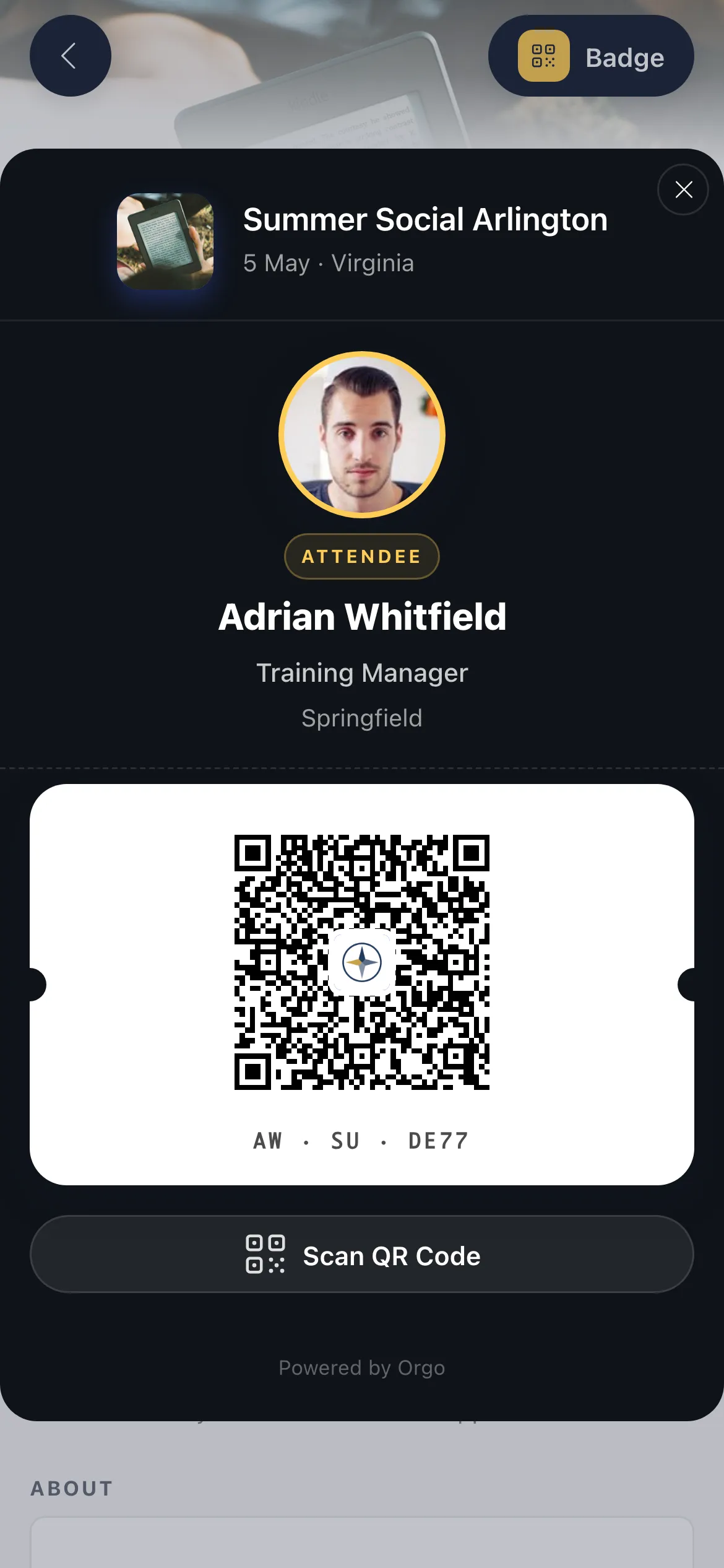 Mobile event app badge screen for Summer Social Arlington on 5 May in Virginia, showing a Badge button at the top right, a circular profile photo ringed in gold above an ATTENDEE label, the name Adrian Whitfield, the role Training Manager and the town Springfield, then a white ticket card holding a QR code and a short reference code, and a Scan QR Code button beneath it
