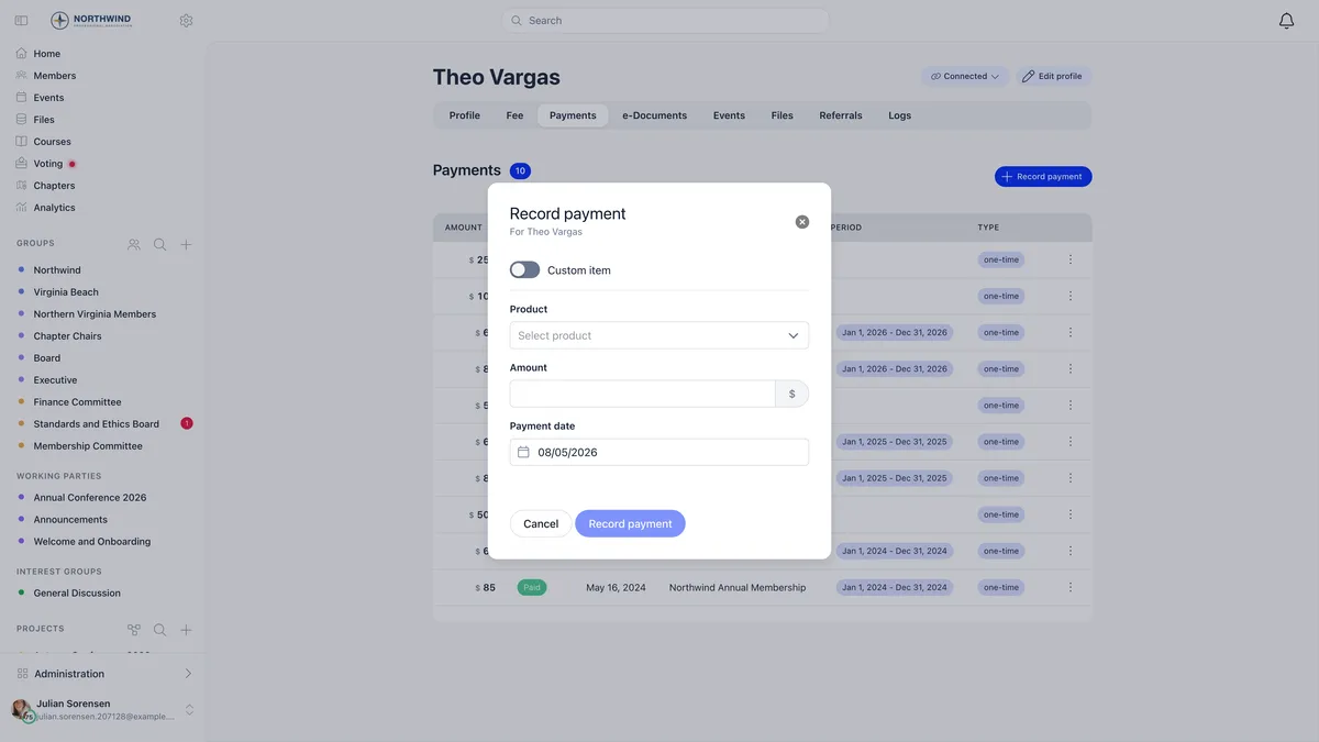 Record payment modal for a member with a Custom item switch, a Select product dropdown, an Amount field with a currency suffix, a Payment date picker defaulting to today, and Cancel and Record payment buttons, over the member's payments list