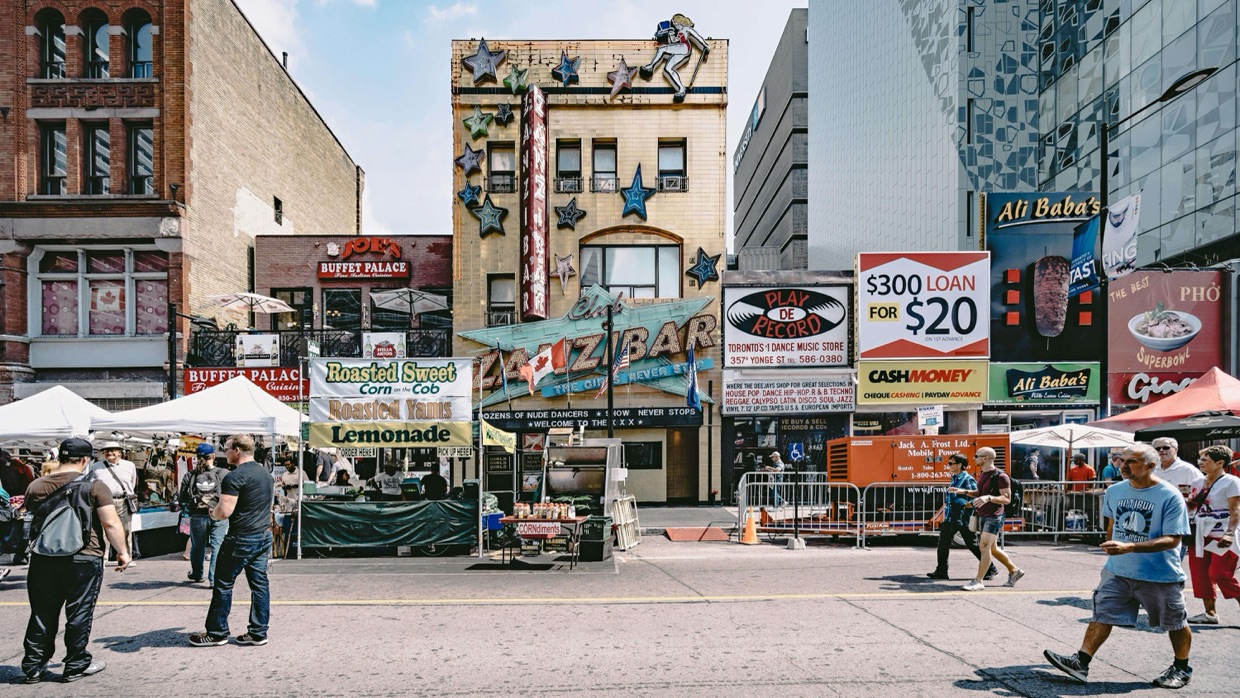 Busy urban district street with local vendors and pedestrians representing a community of place